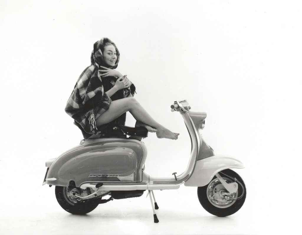 1958 lady sitting on Lambretta scooter with blanket