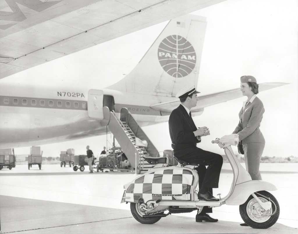 1960 man and lady with Lambretta scooter in front of Pan Am airplane