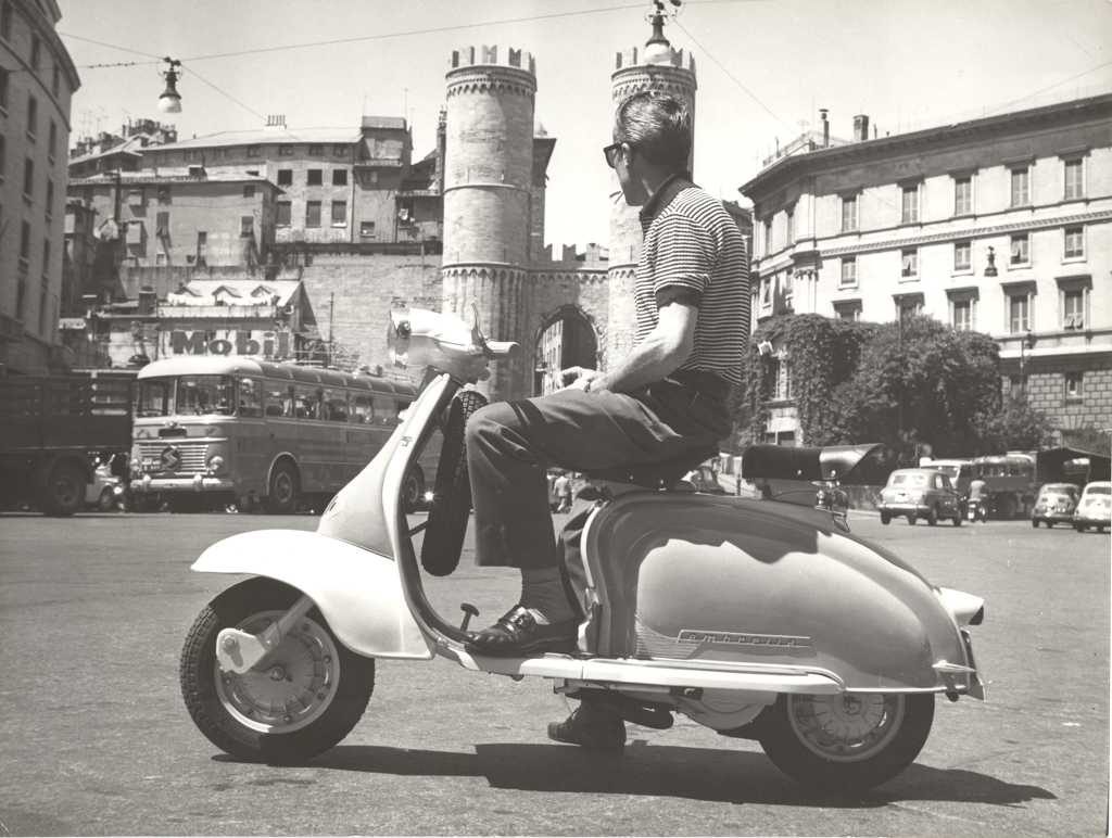 1960 man on Lambretta scooter on square