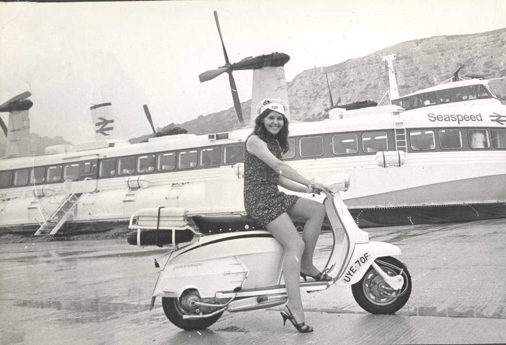 1966 Lambretta scooter with woman in fornt of Seaspeed boat