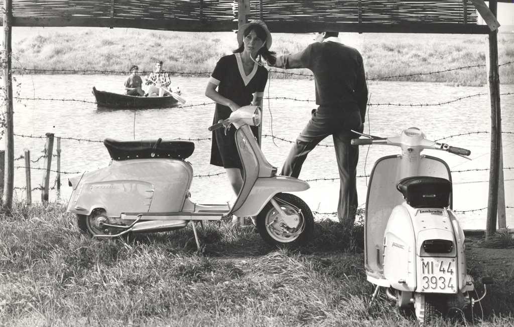 1968 men and woman with two Lambretta scooters river