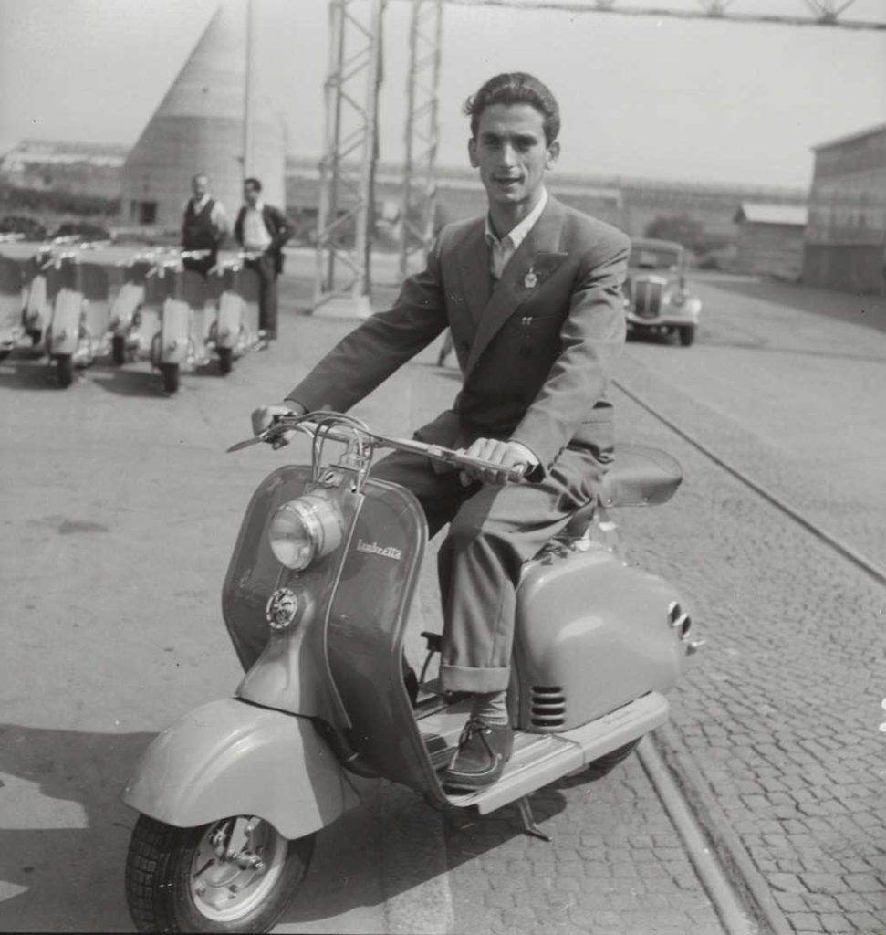 Motorcycle road racer Umberto Masetti with Lambretta scooter