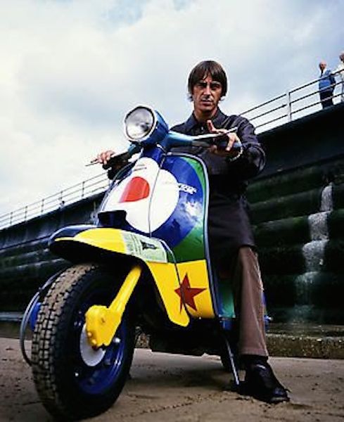Paul Weller on colored Lambretta scooter